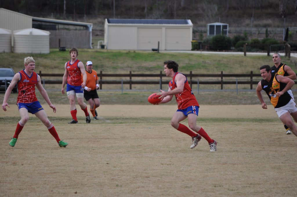 TEAM WORK: Redbacks Andrew Politch and Alex Cutmore come to the aid of team mate Brendan Iles. Photo Linden Morris / Warwick Daily News